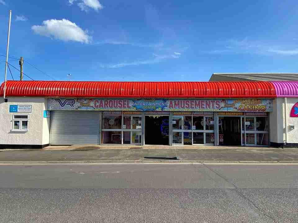Front shot of the dog friendly Carousel amusements in Hornsea with a blue sky.