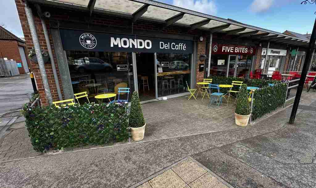 Front of Mondo Del caffe - A dog friendly cafe in Hornsea showing the shop front, dog bowl and tables and chairs outside.