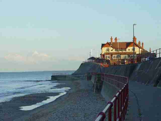 Shot of the dog friendly Hornsea pub The Marine when looked at from the railings with the sea and beach on the left.