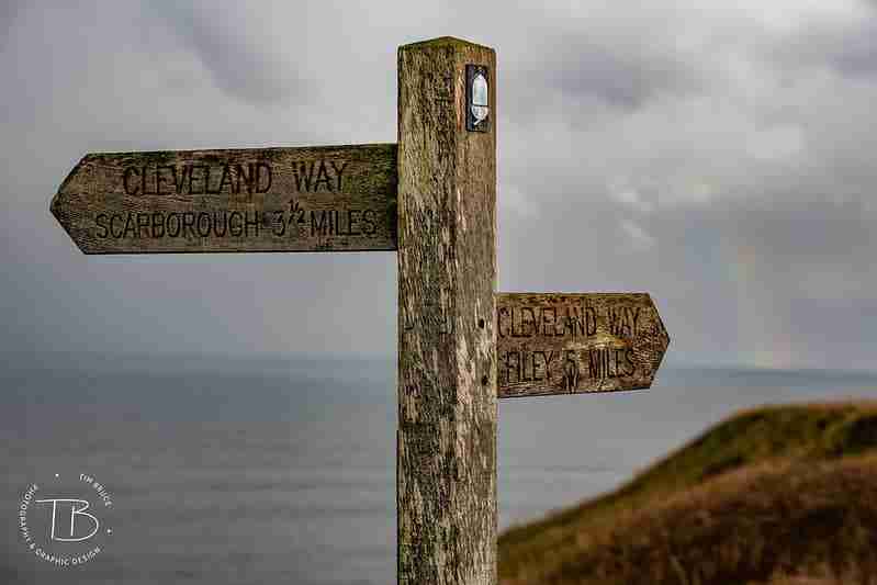 Signpost showing the Cleveland Way in both directions on a cloudy day by Tim Bruce