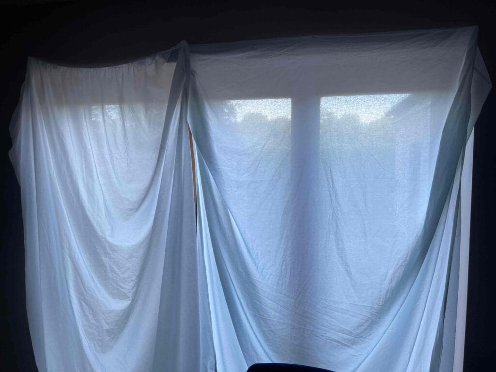 Bed sheets hanging to block out light in the kitchen
